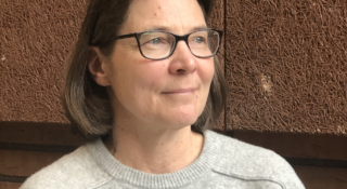 Silmälasipäinen, keski-ikäinen nainen