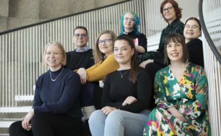 Joukko naisia istuu portailla.