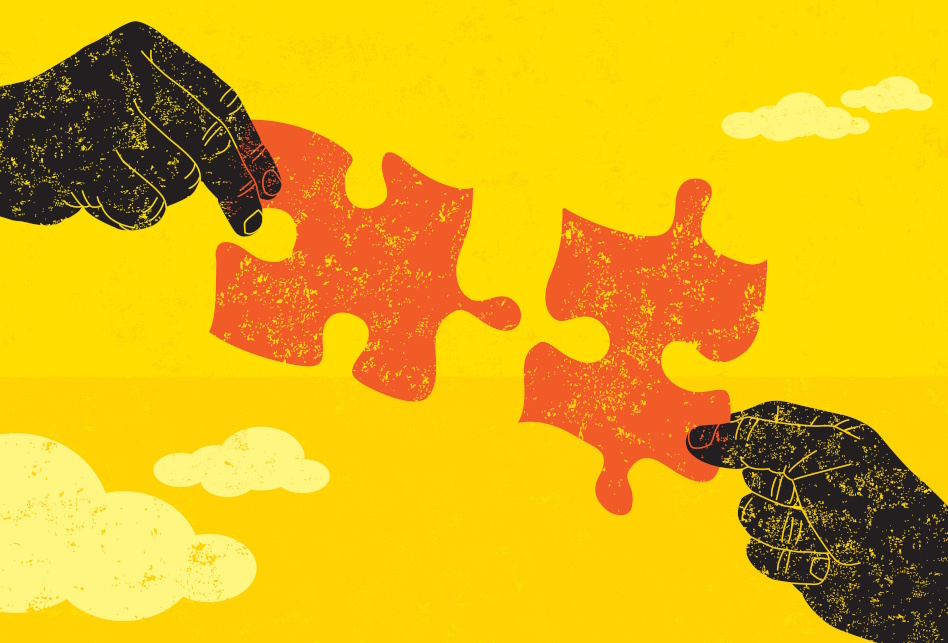 Kaksi piirrettyä kättä pitää kahta palapelin osaa